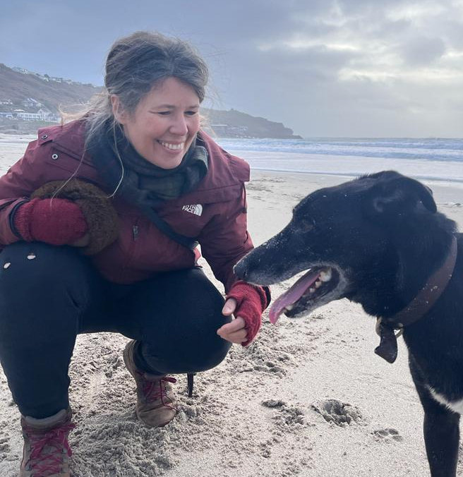 Ruthie Baigent on the beach with her dog
